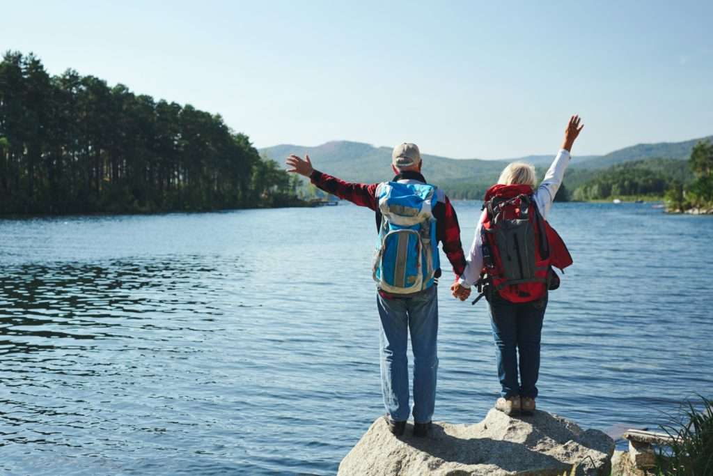 Older couples enjoy their vacations funded by smart retirement investment plans - Omega Insurance Brokers"